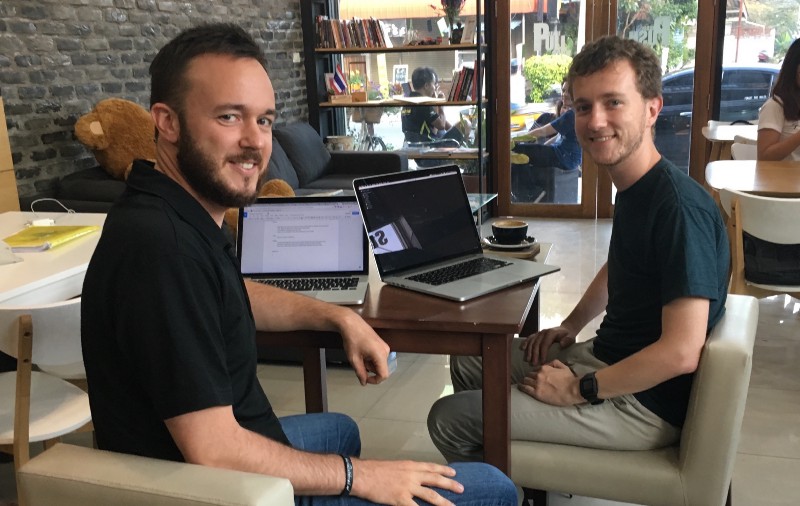 Anthony (left) and Alexis (right) comparing React and Vue at Bull and Bear Cafe in Chiang Mai, Thailand
